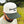 Right-side view of a man wearing an ivory and dark green two-tone snapback hat with an embroidered flying bobwhite quail and 'Bobwhite Quail' script on the front, worn outdoors.