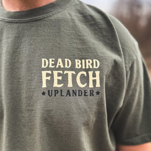 Front chest detail of an olive green t-shirt with text 'Dead Bird Fetch, Uplander'.