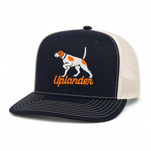 Black and cream trucker hat with an embroidered orange and white English Pointer and 'Uplander' script in orange.