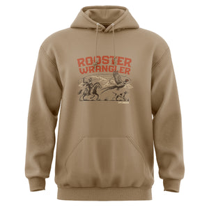 Front view of a tan hoodie featuring a graphic of a man riding a horse lassoing a pheasant with his bird dog, with text 'Rooster Wrangler, Uplander'.