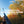 First-person view of a hunter holding a shotgun aimed skyward as a ruffed grouse flushes into a golden autumn aspen forest under a blue sky, with text reading 'Wings Erupting From Golden Aspens — A Thunderous October Flush.'