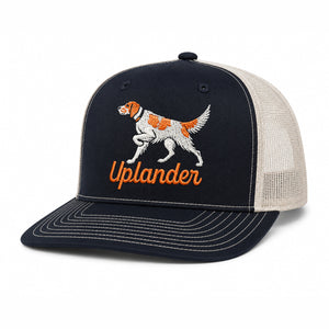 Black and cream trucker hat with an embroidered orange and white English Setter and 'Uplander' script in orange.