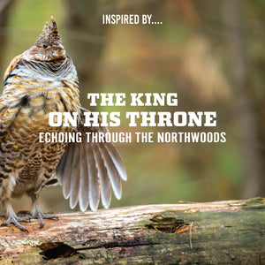 A ruffed grouse drumming on a mossy log in a northwoods forest, with text reading 'The King on His Throne — Echoing Through the Northwoods.'
