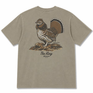 Back view of a tan t-shirt featuring a detailed illustration of a ruffed grouse with tail fanned, with 'The King,' 'Heritage Series,' and 'Uplander' text.