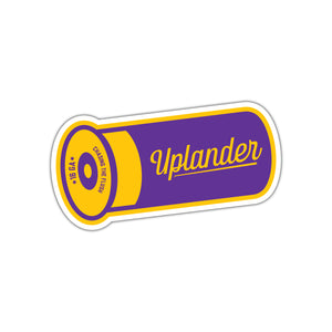 Die-cut sticker of a purple and yellow 16 gauge shotshell, with text 'Uplander, Chasing the Flush'.