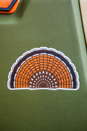 Die-cut sticker of a red phase Ruffed Grouse tail fan on a green dog kennel.